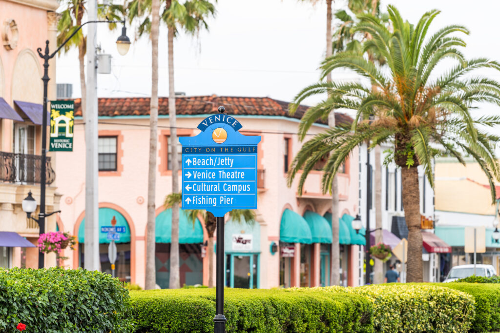 Venice Florida city sign and coastal scenery illustrating Venice's growth and appeal to buyers.